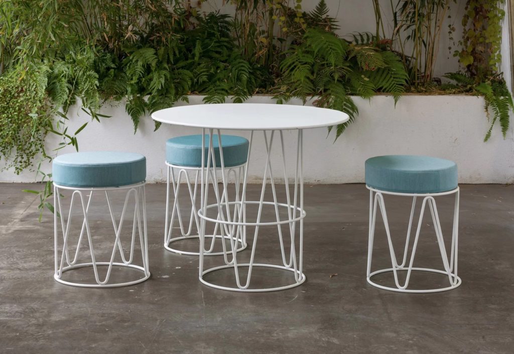 Three stools with white frame/blue cushions and white café table