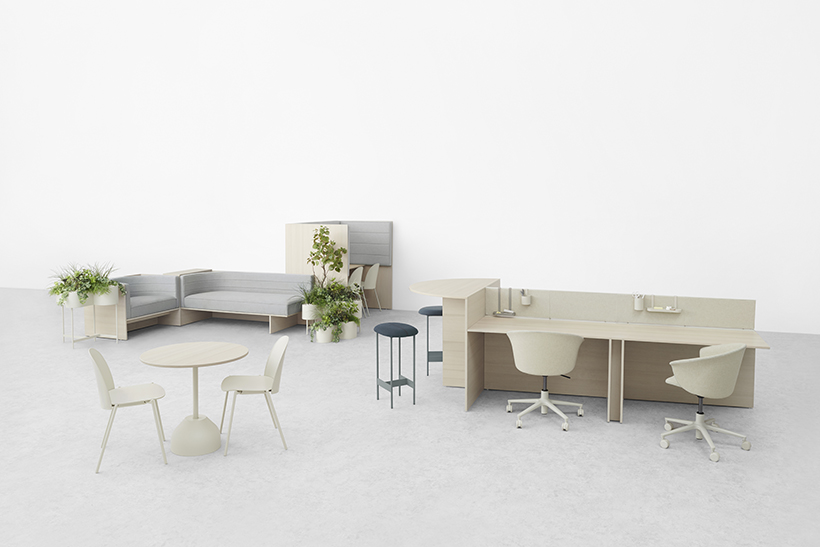 office furniture from Iris Chitose: café table with chairs; dual workstation with task chairs and bar feature with stools; sofas with planters; and work carrel with sound absorbing panels