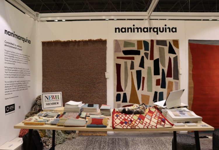 Nanimarquina booth at BDNY with rugs on wall and fabric swatches