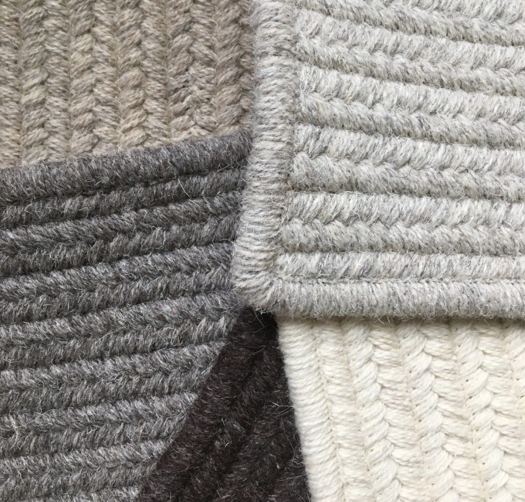 Detail of rug fibers in white, grays, and black