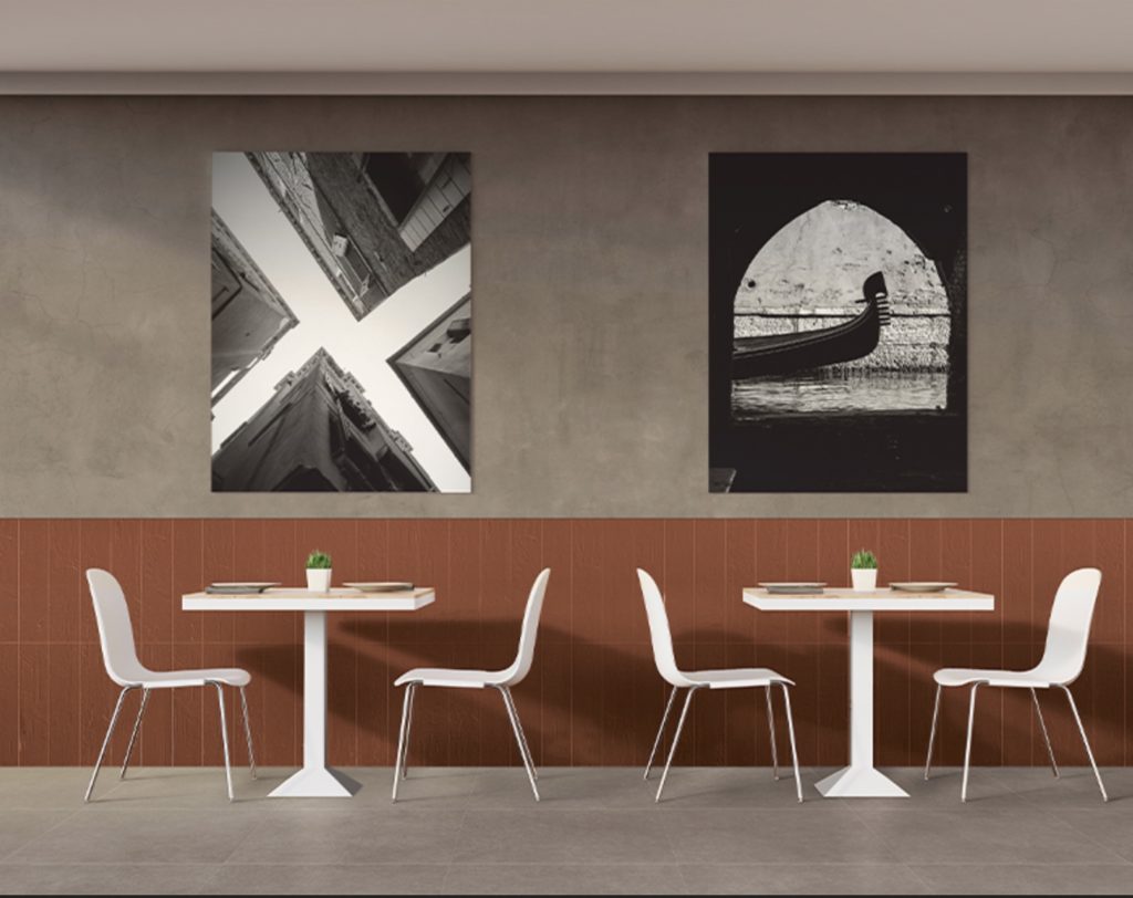 tiles on wall at cafe in a rust color with white tables and chairs and interesting black and white photographs