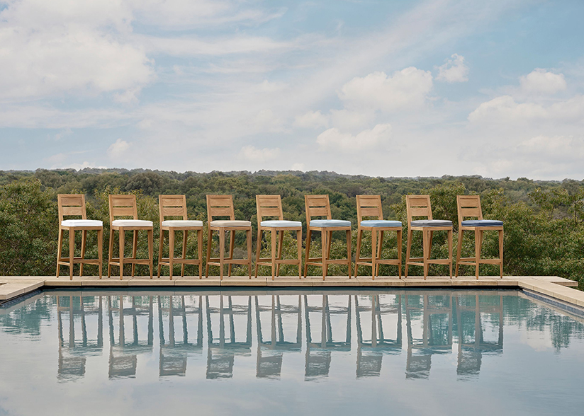 Vegan leather on outdoor stools in front of pool with shrubby hills in the background