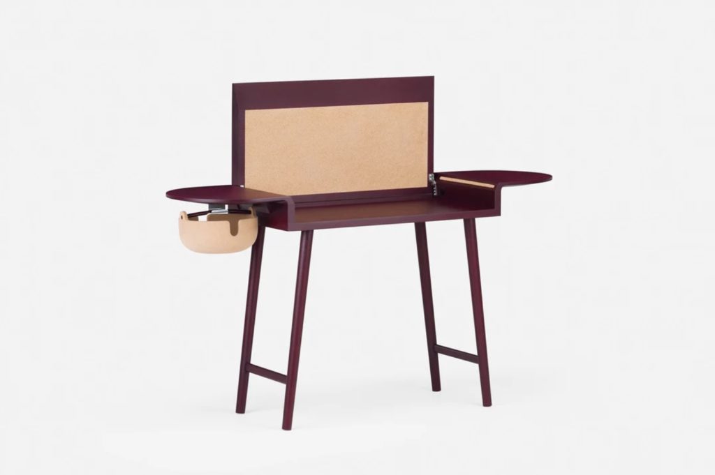 Walnut desk in open position with tackable cork surface