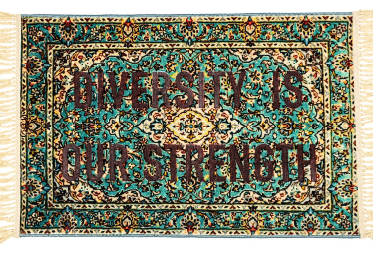 Diversity is out strength carpet with words over ornate blue/green Persian-style carpet