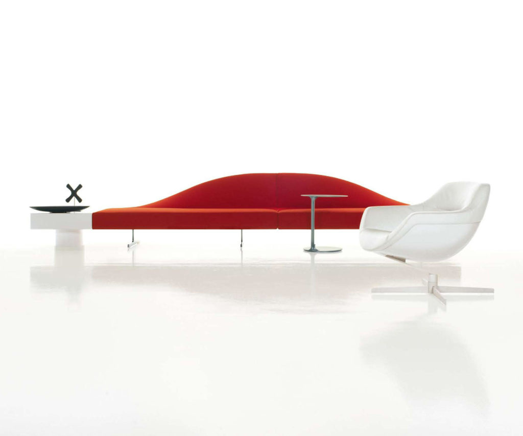 Two sofas in red joined with white chair and white side table
