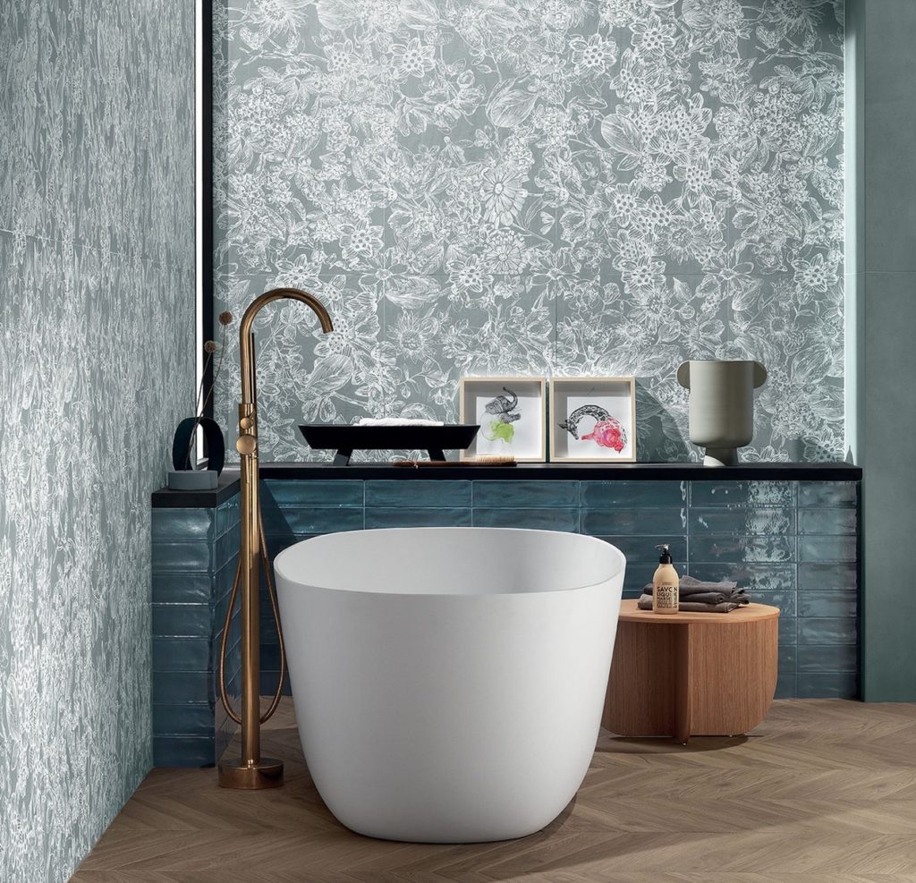 stoneware tiles above tub with same floral pattern of white/minty green 