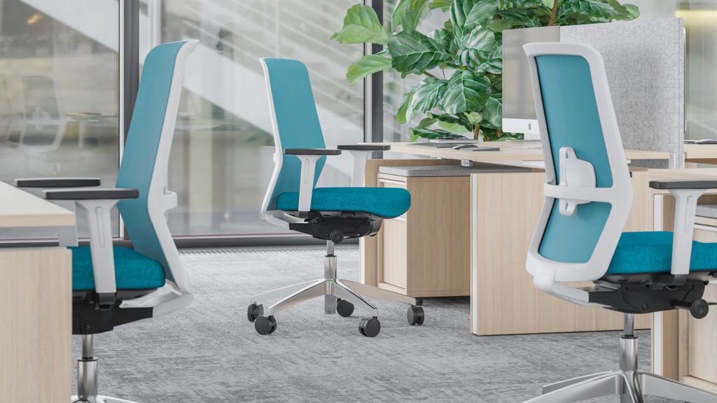 Three task chairs in office in an aqua blue color