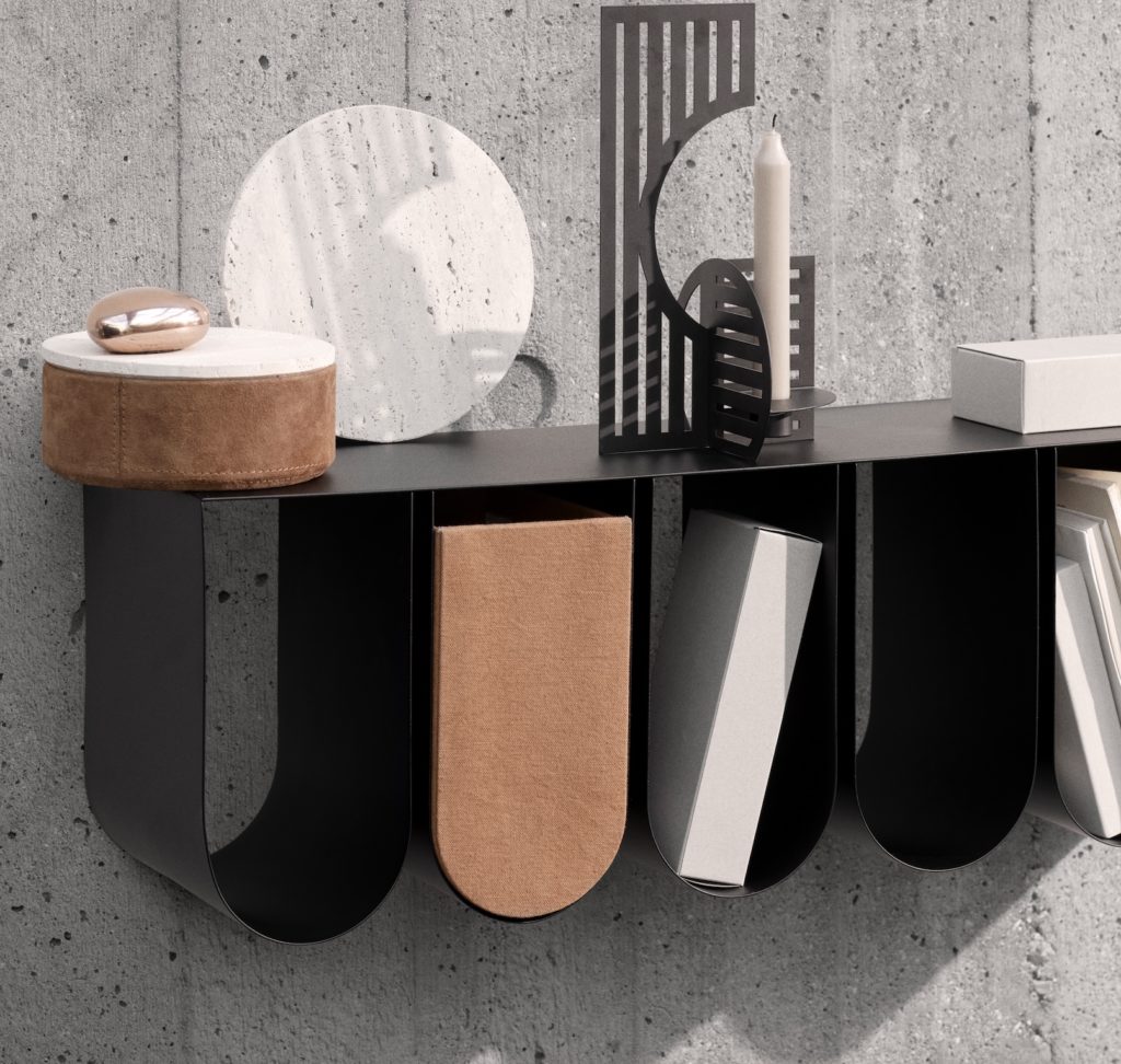 Close view of wall shelf in black with varied items in the five compartments