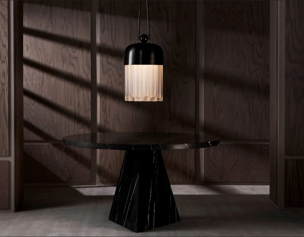 Tassel light with black dome above table