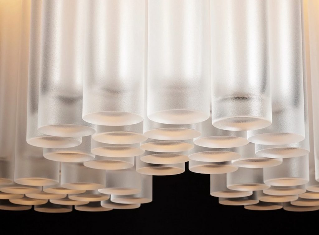 detail of glass cylinders in a designer chandelier