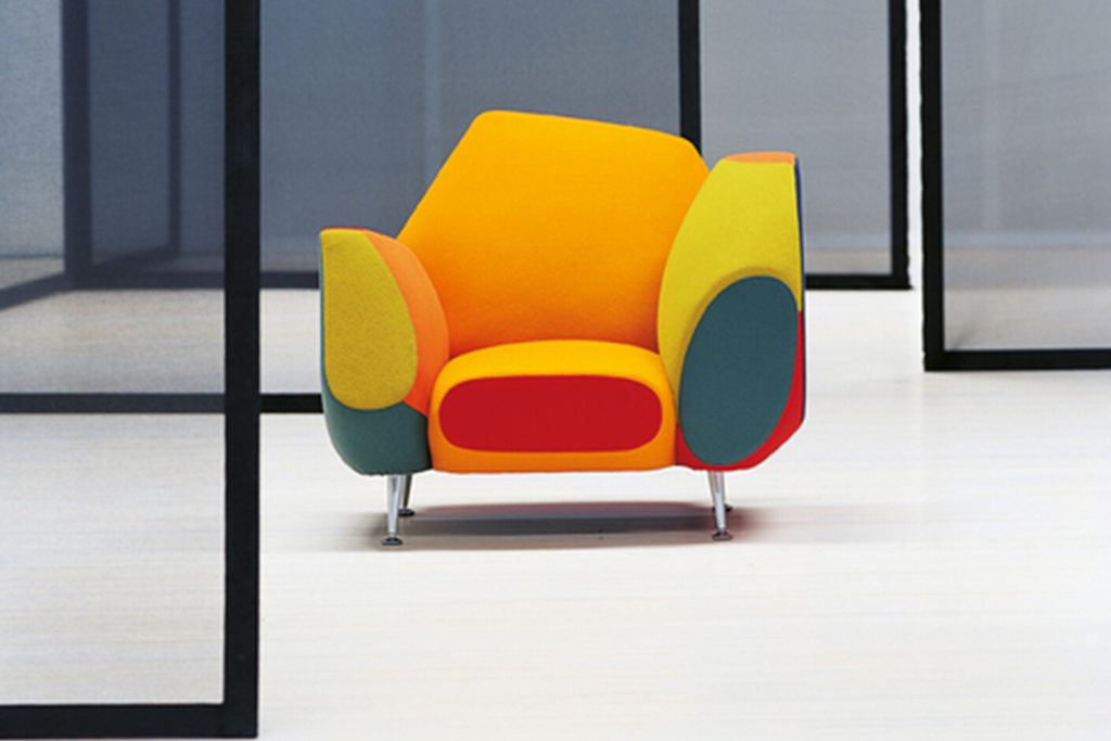 Grand Suite multi-colored armchair with different height arms and a pentagonal back