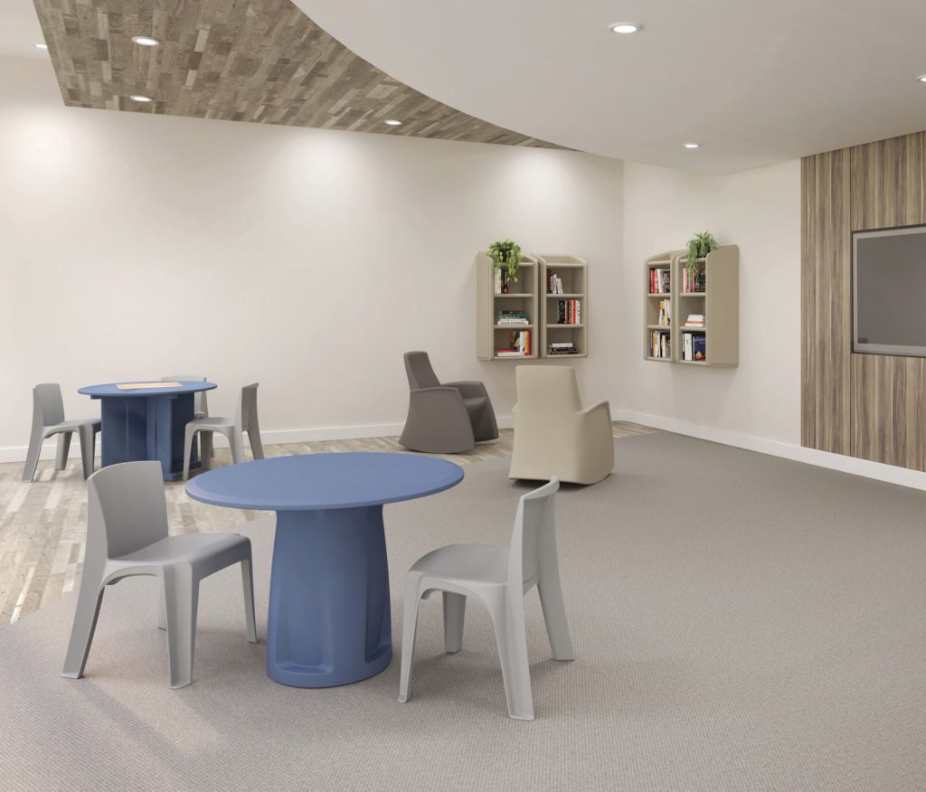 gray chairs and blue tables in patient rec room