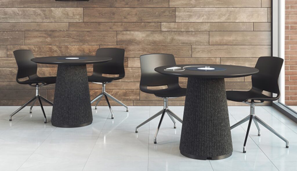 Two Ember tables with black tops and black felt bases with black chairs