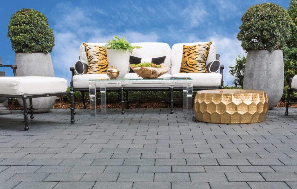 Gray pavers with comfy outdoor furniture and planters