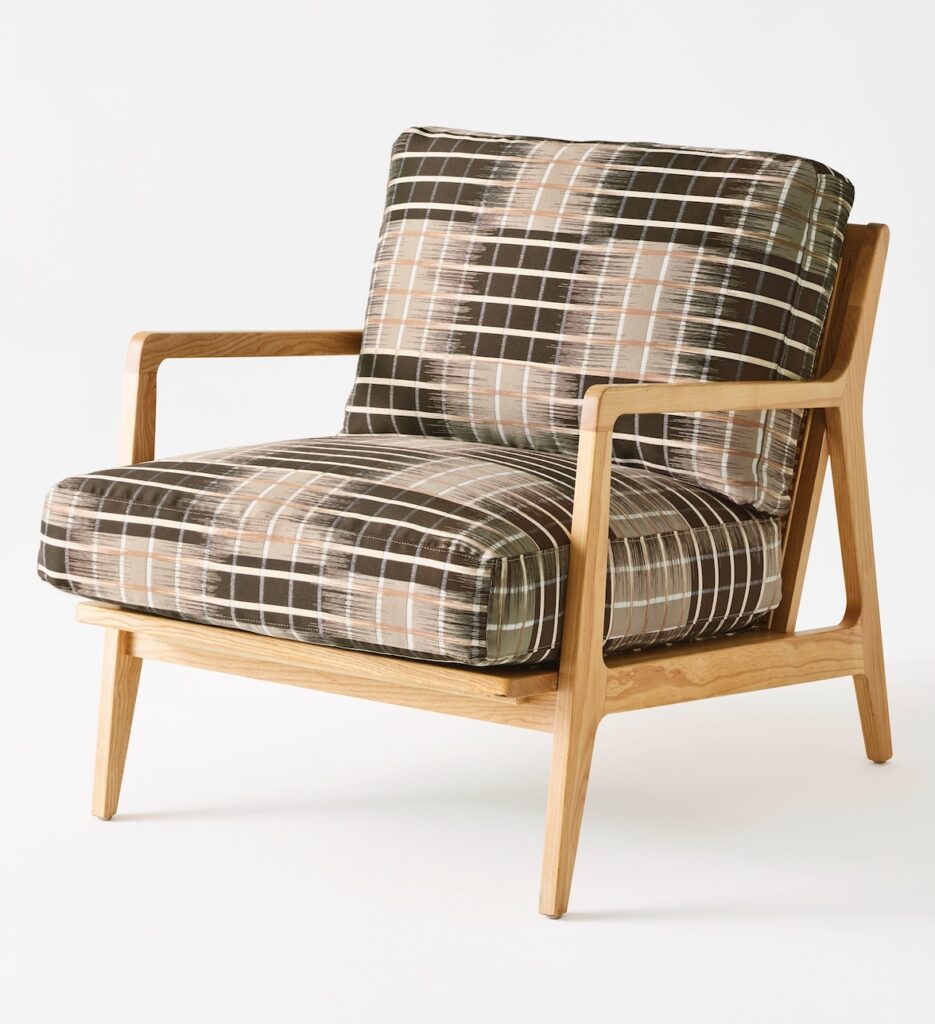 Tone fabric on chair with squares in tan and chocolate brown and blurred white lines going across