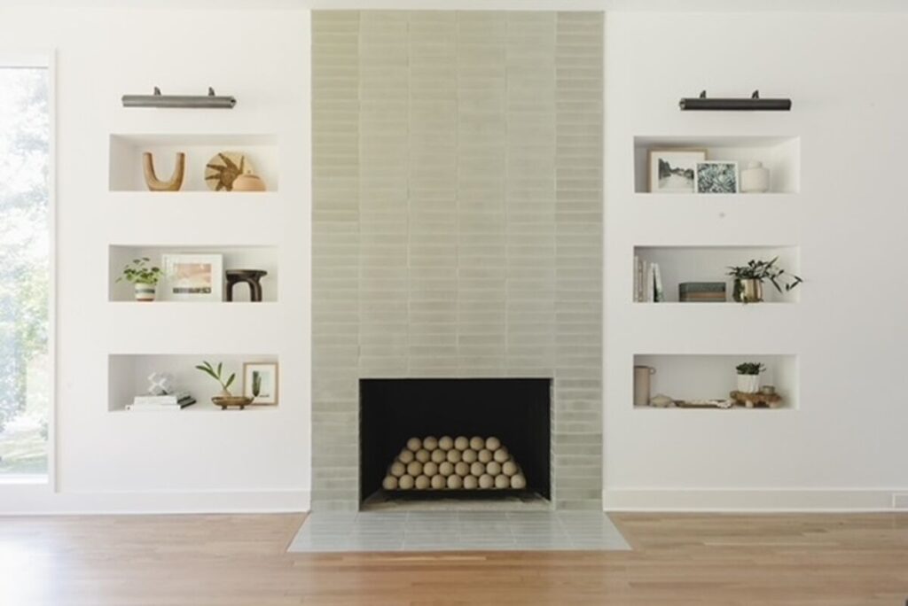 Fireclay tile thin brick tile with built in niches surrounding open fireplace