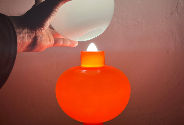 1.0 light at Launch Pad. Light with glass shade and filament that looks like a candle flame