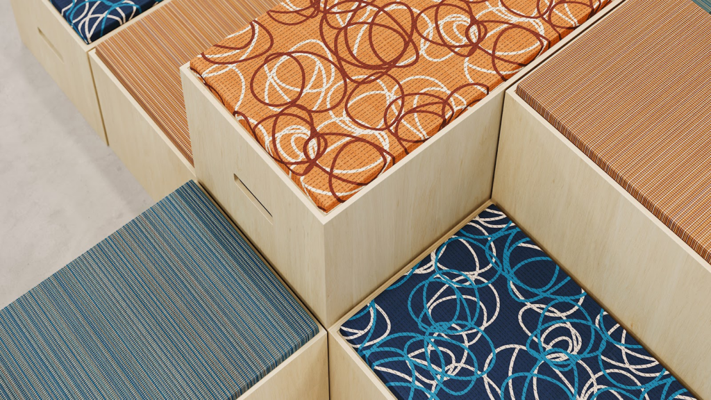 Curve textile with hand-drawn circles in various colors on stackable seating blocks