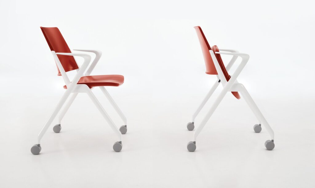 Two chairs side view, red, one with seat down and one with seat flipped up 