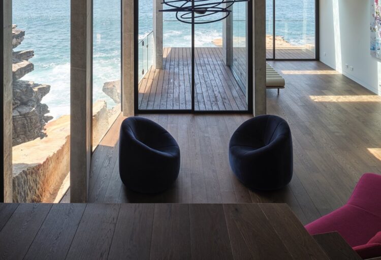 Quadro flooring in minimalist seaside cottage with lots of glass