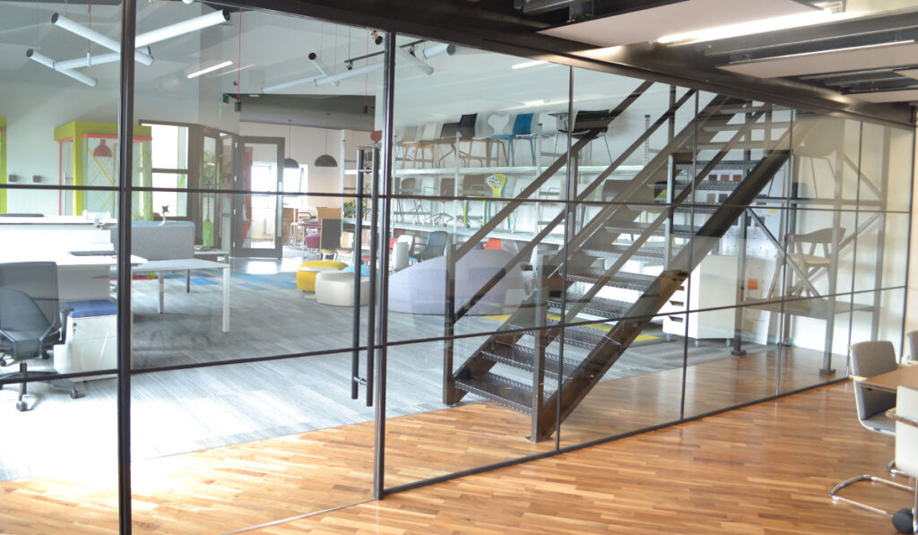 Glass wall with thin black glazing in open office