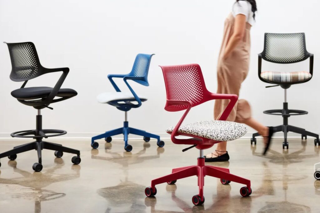 Four Picado chairs in various colors and two heights with woman