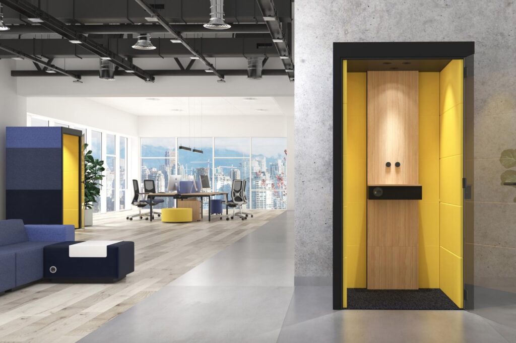 Silent Room pod with black exterior and yellow/light wood interior in long, open office space