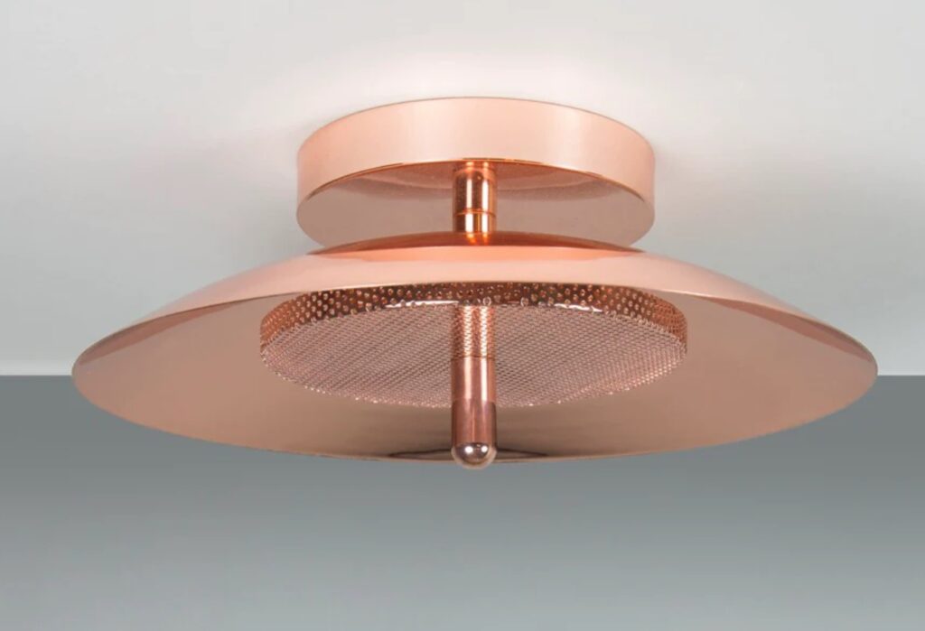 Close up of flush-mounted lamp with copper shade