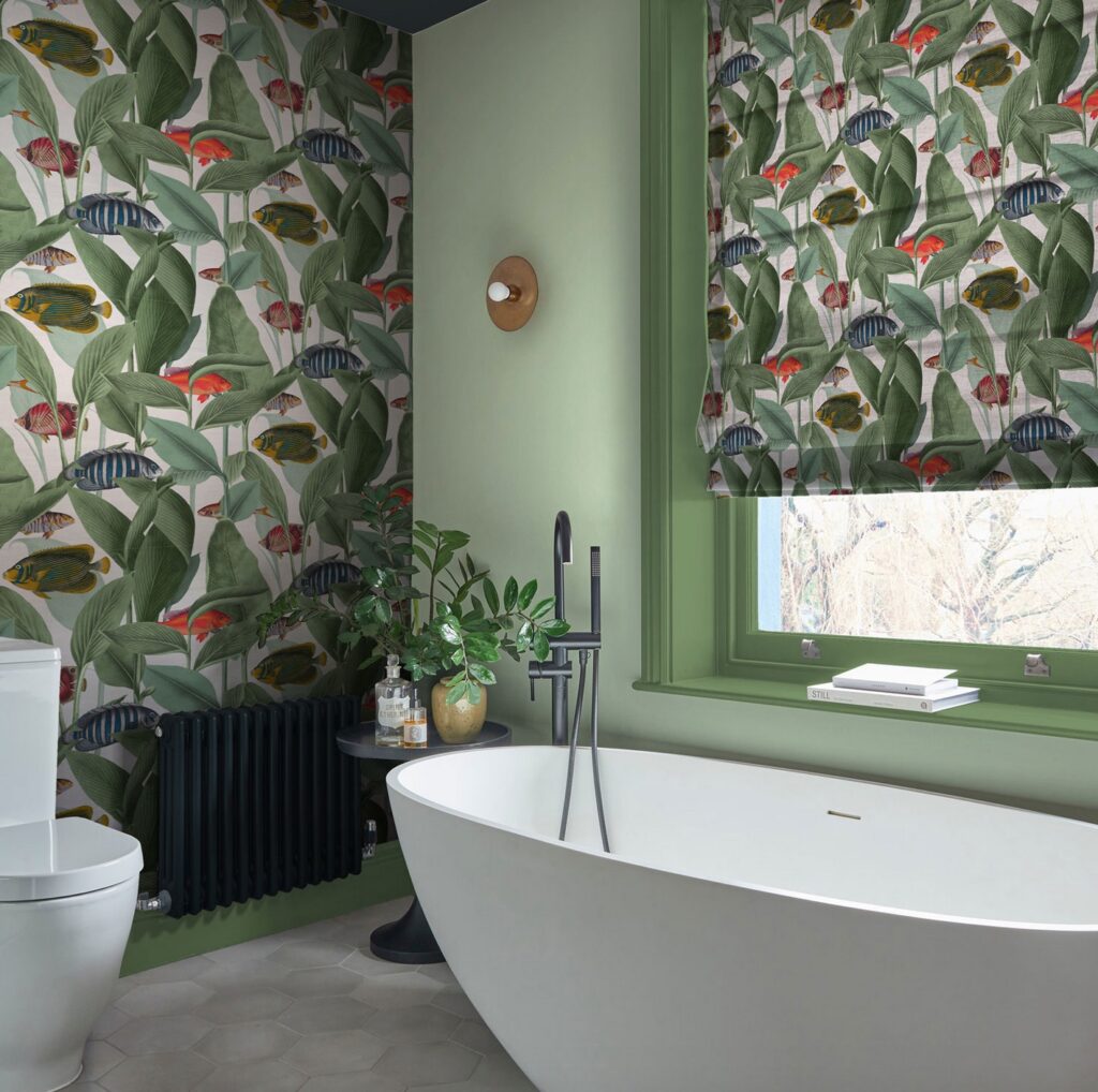 ocean scene on wallpaper and roller shade in pleasant bathroom