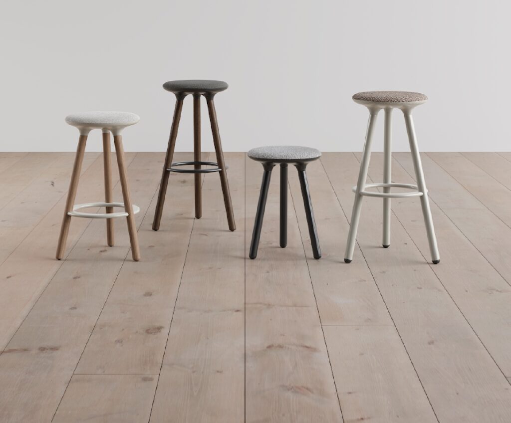 Trine stools in four different finishes on wooden floor