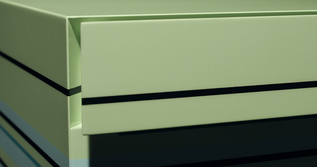 Suzanne detail of chest of drawers with single drawer in green with colored stripes