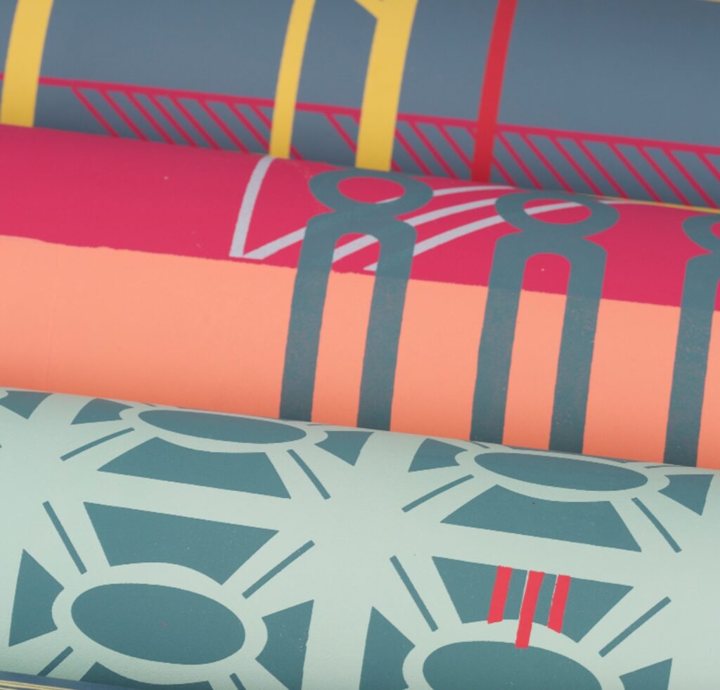 close up of rolls of vibrant wallpaper with geometric designs