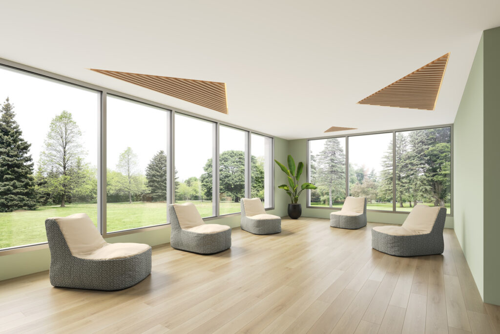 Five Kiwi chairs in contrasting white/green fabric in open space with large windows looking on part-like setting