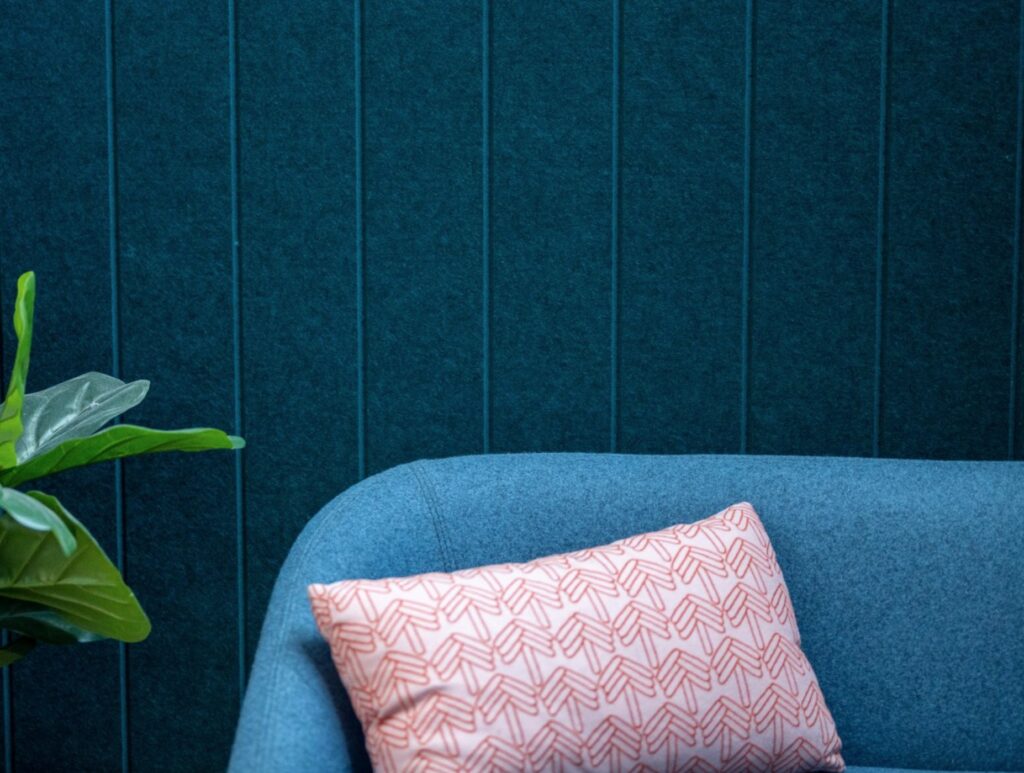 Acoustical material on wall and sofa in different shades of blue