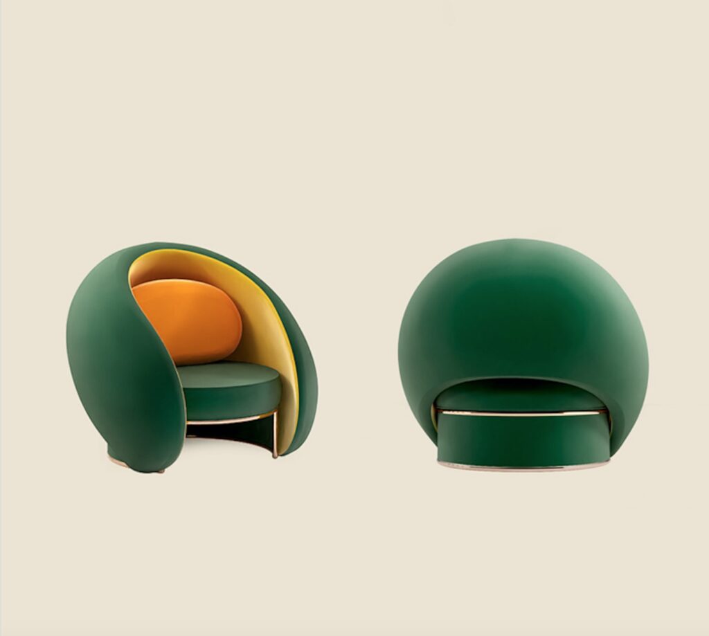 Green chair with orange cushion one facing front one back