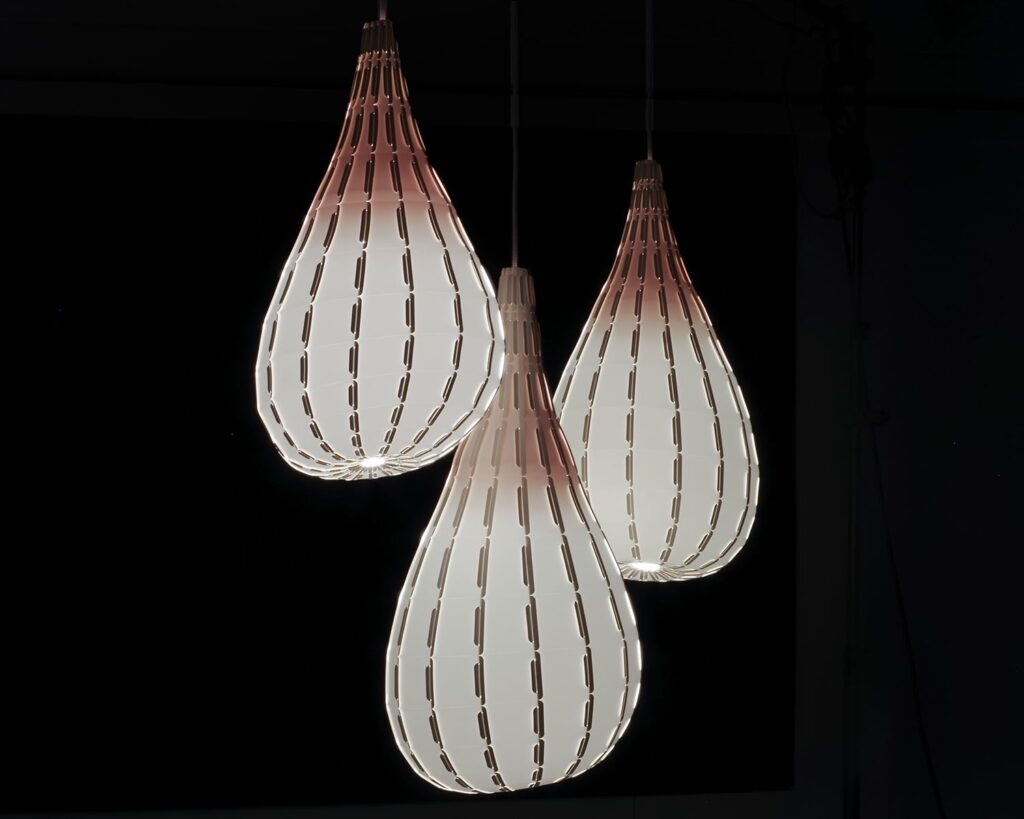 Three pendant lights in a gray tone with red at top