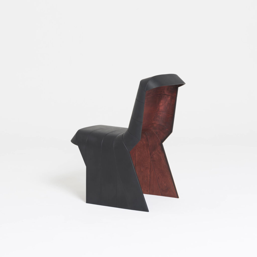 Luca chair side view with wood visible beneath and black painted surface