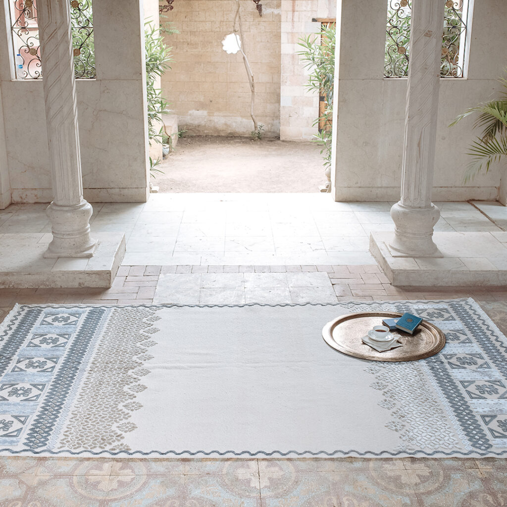 Hand-woven rug on the floor of portico with nice tile and stonework