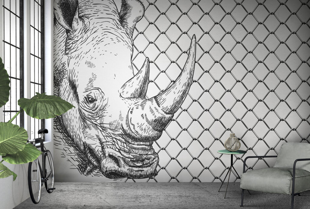 Black and white rhino with chain-link fence