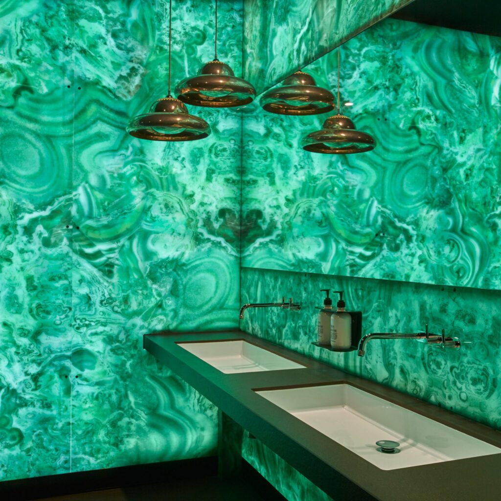 Greenish, swirling, aquatic design in bathroom