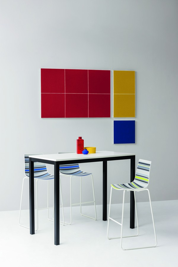 Colorfive stools at high table with primary color design on wall 