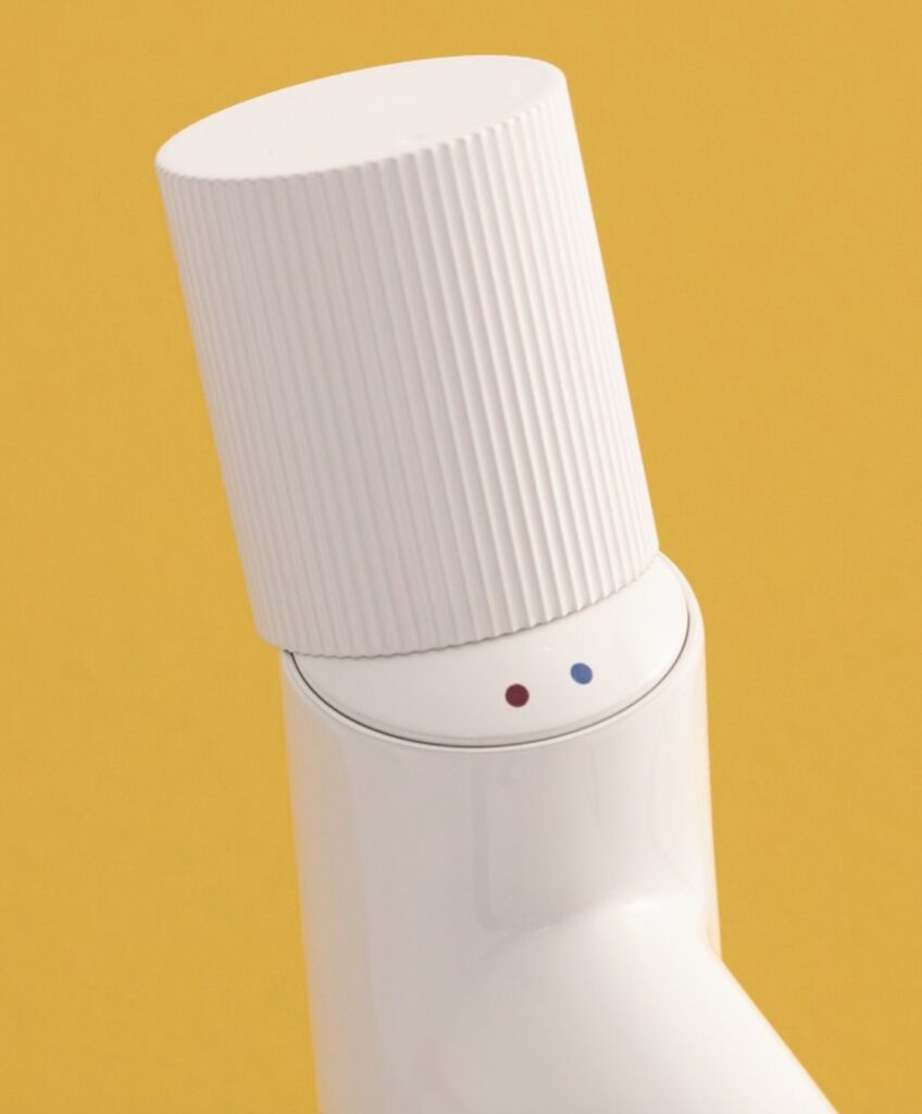 Detail of Roca, Nu bathroom tap handle in white with red and blue dots to indicate hot/cold