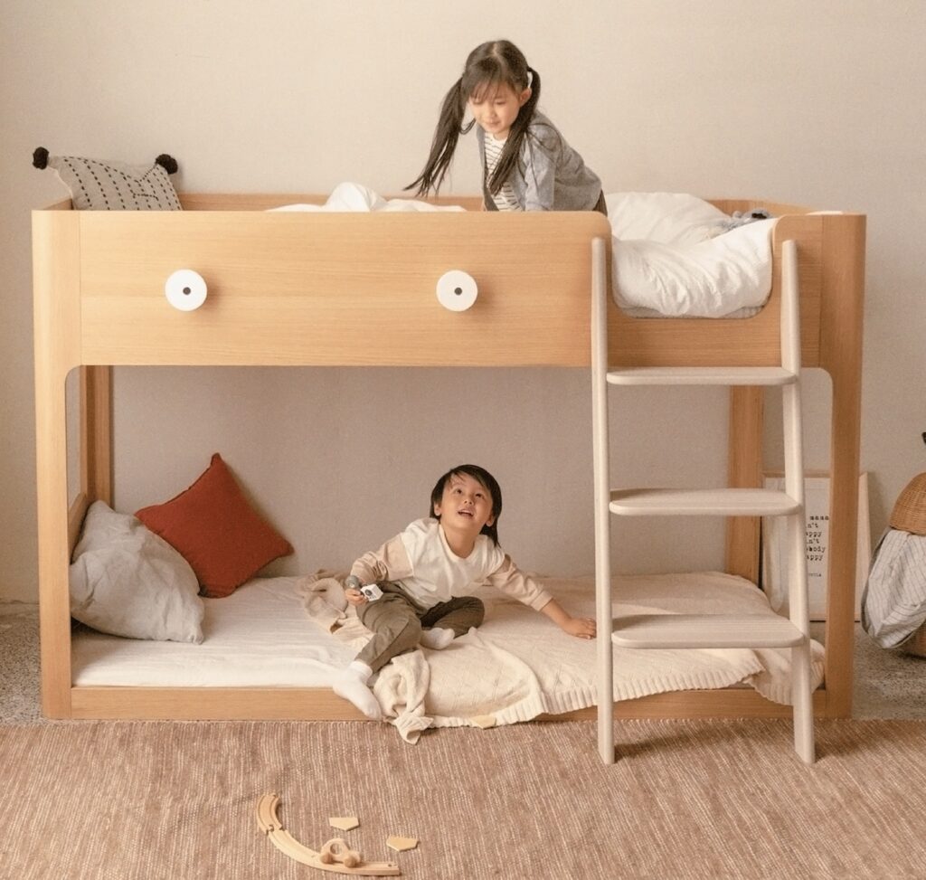 Kids on lower and upper bunks of bed