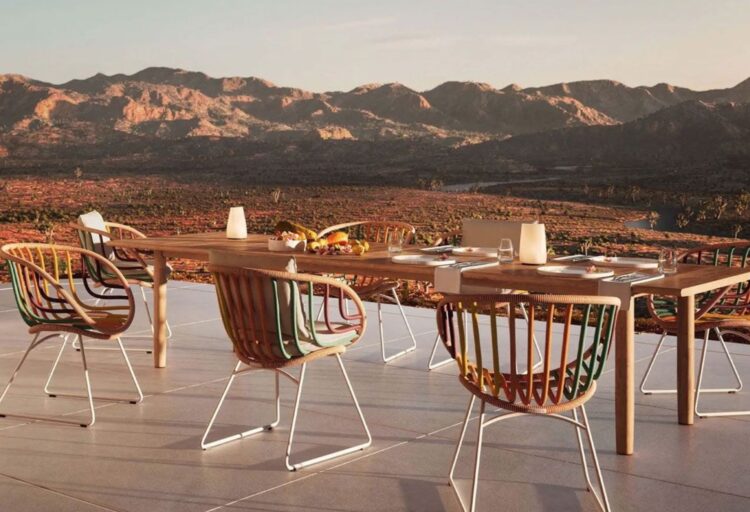 Dedon Kida Armchairs in Line Glow on outdoor patio with view of mountains