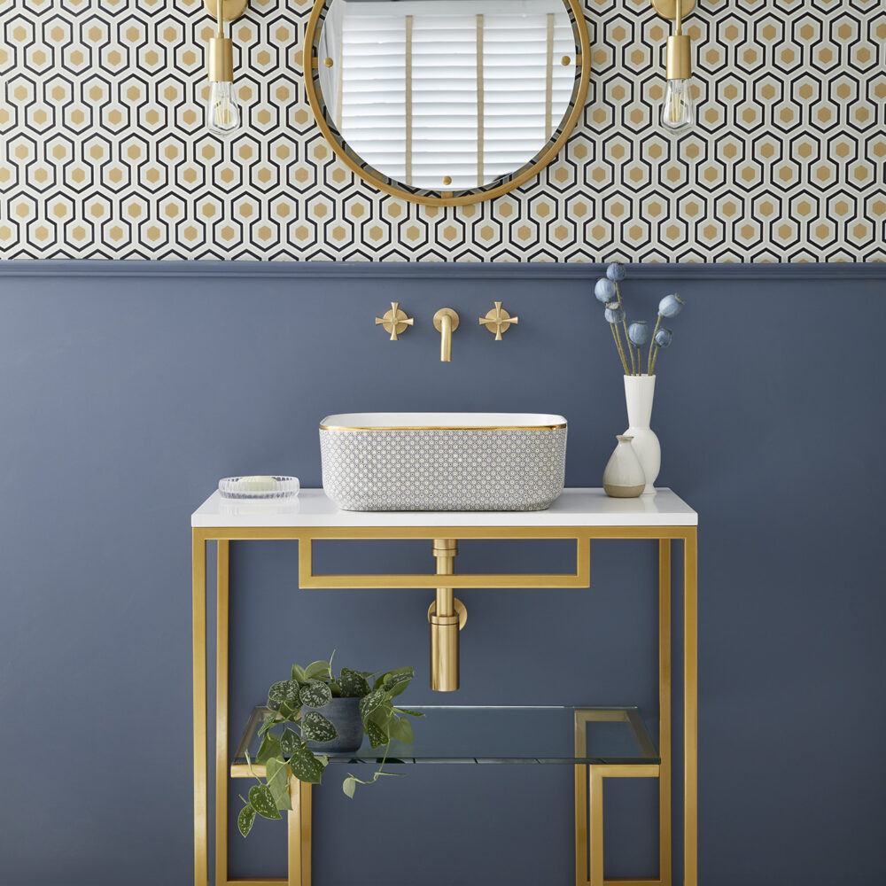 Hugo vanity with gold legs and frame and Alara sink with geometric design and gold band