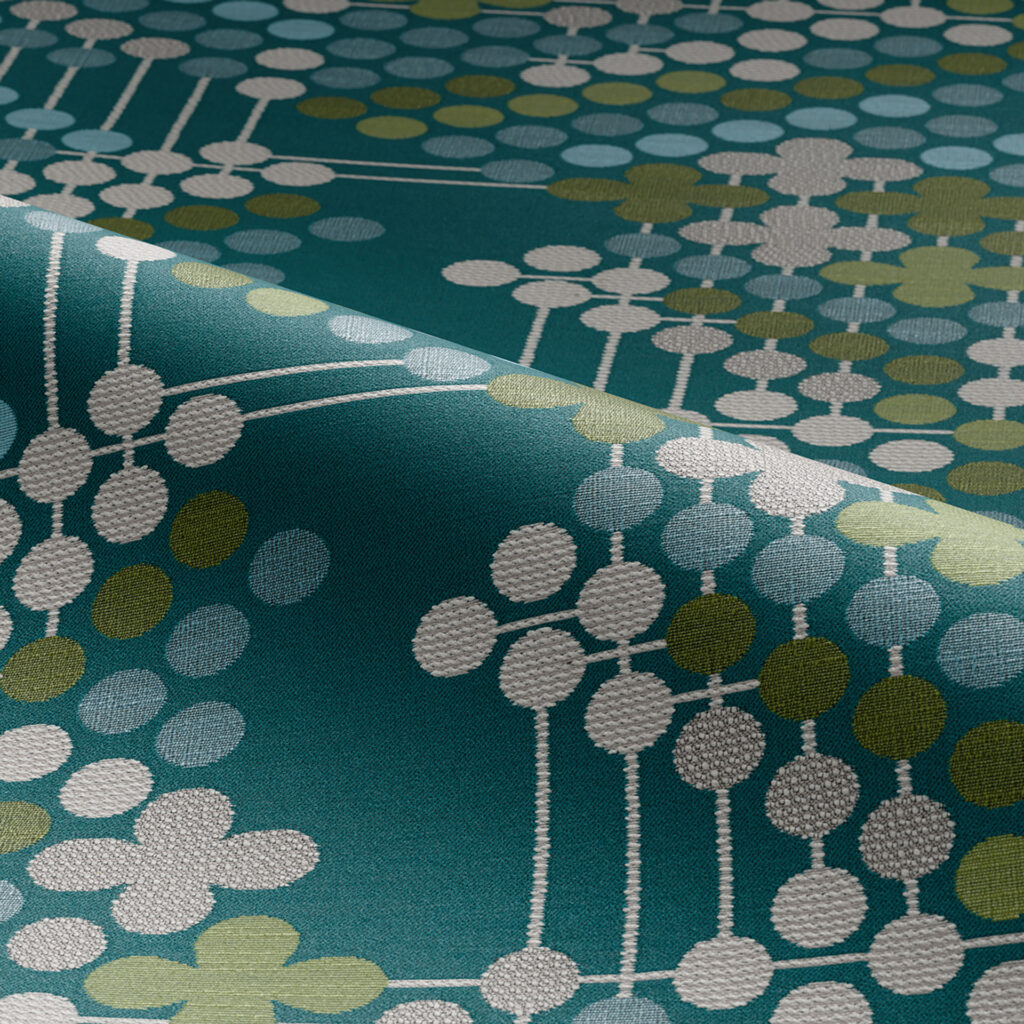 Circulate detail of fabric with green background and white, blue, and brown/grey dots
