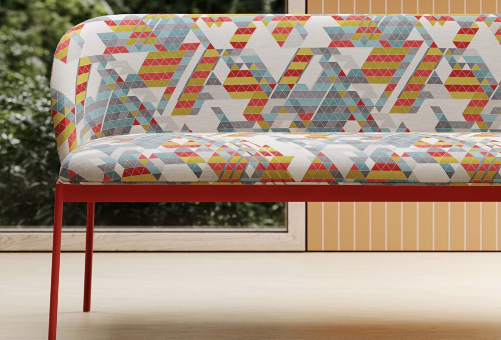 Vertex colorful fabric on slim sofa with greenery beyond