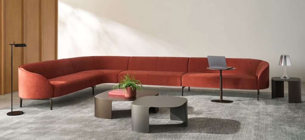 Modular lounge in orange/rust angles configuration with tables and lighting