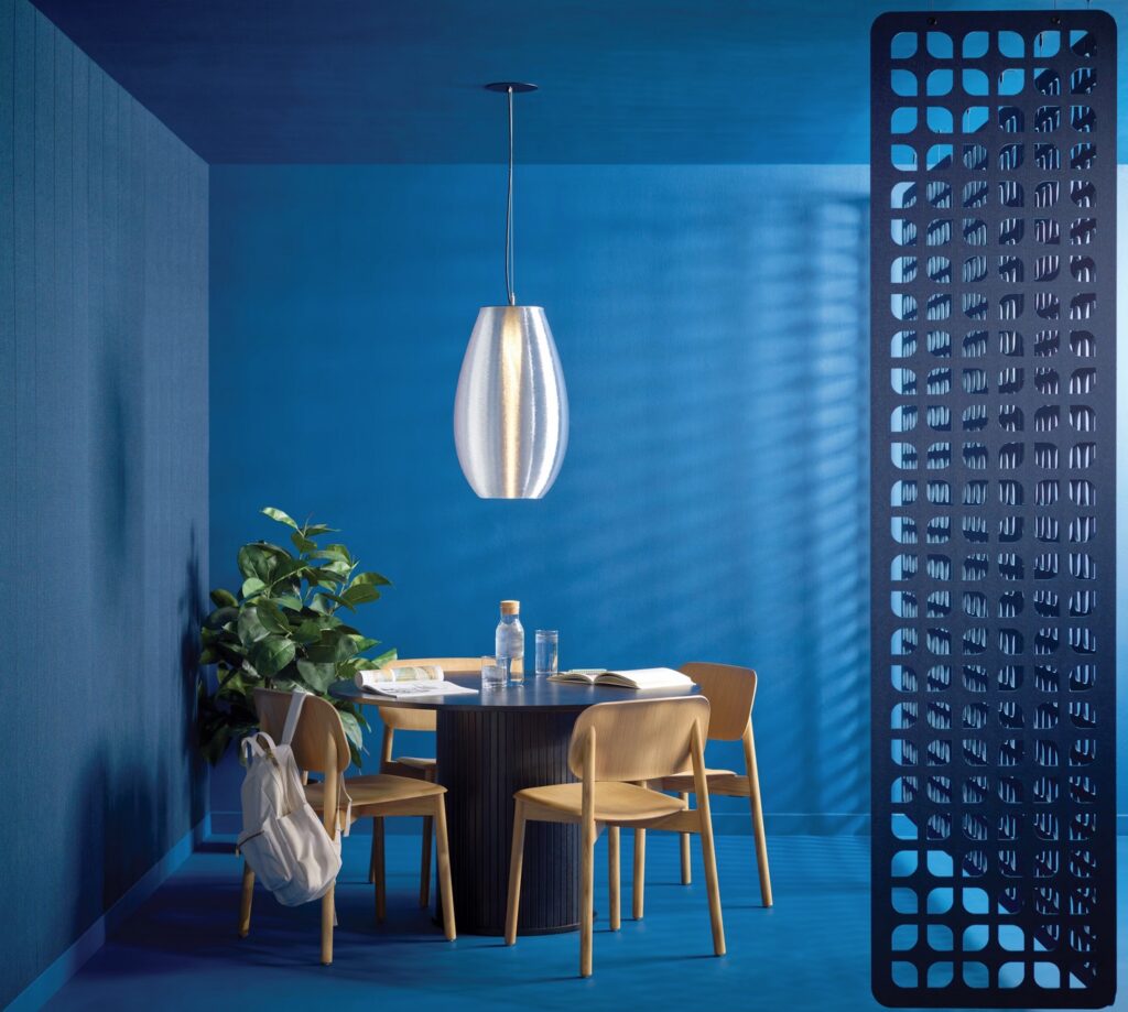 Clear Coil M6 pendant in blue room with table