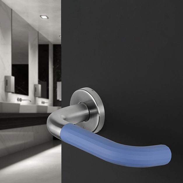 A textured blue TOCCO handle leading into a bathroom. 